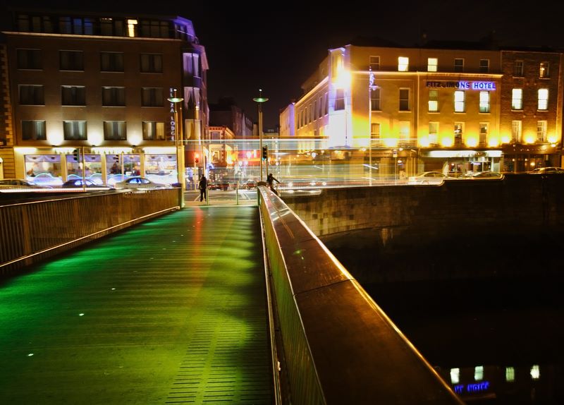 Brass, Steel, Concrete and Neon: View of Temple Bar, Dublin, Ireland, from a bridge over the River Liffey.